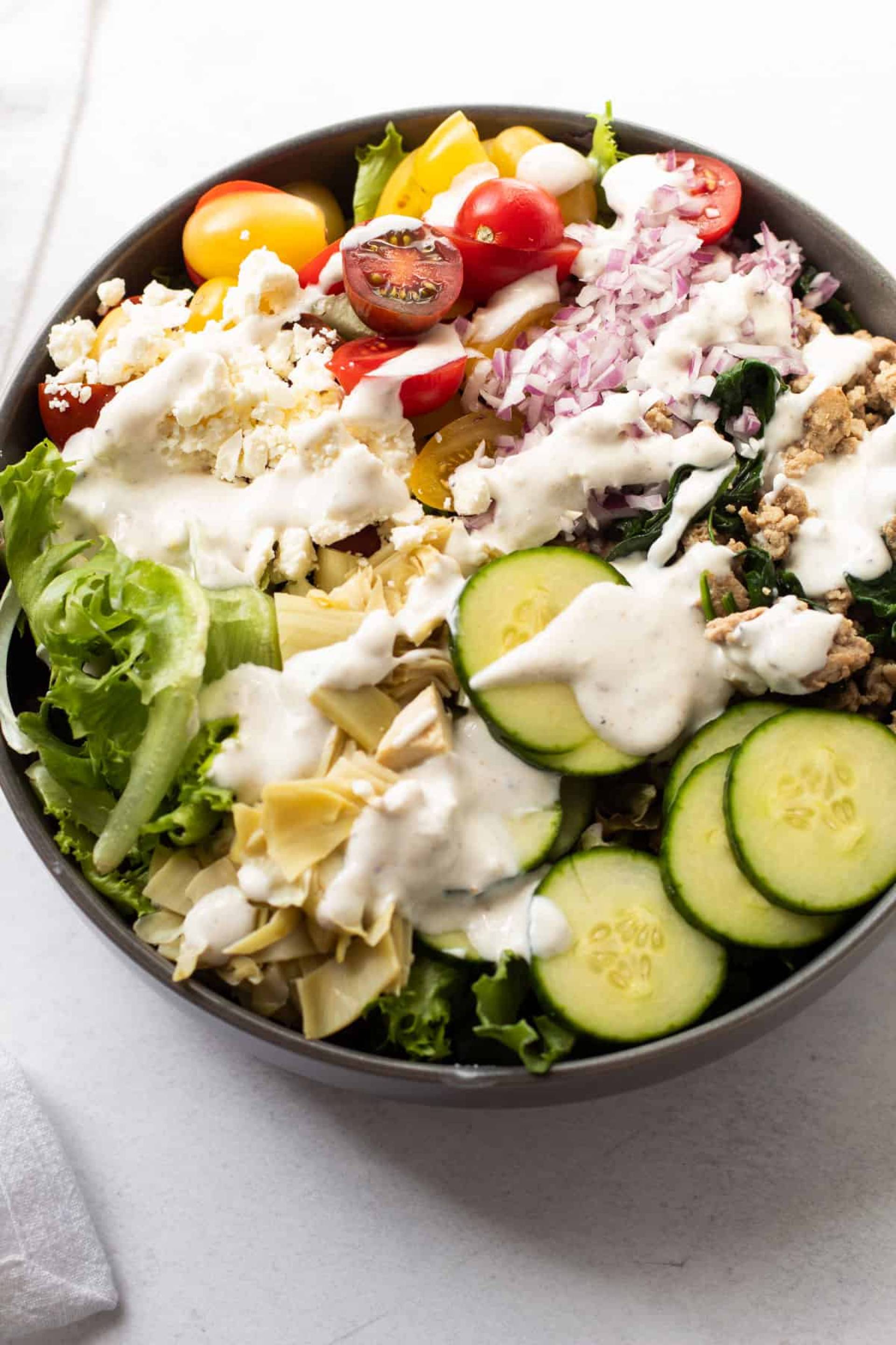 Keto Roasted Turkey Salad w/Mixed Greens, Cucumber, Rainbow Tomato, Eggs, Sharp Cheddar, Blue Cheese, Red Onions, Sunflower Seeds & Vidalia Onion Vinaigrette.