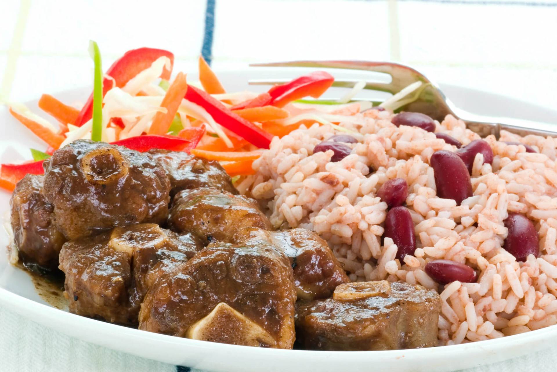 Slow Cooked Oxtails w/Butter Beans...Rice & Peas, Plantains &  Cabbage Slaw