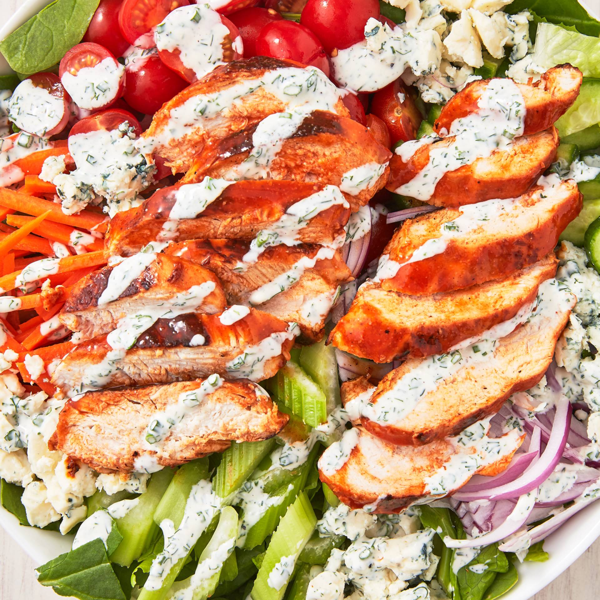 HEALTHY PORTION-Buffalo Chicken Salad w/Mixed Greens, Red Onions, Cucumber, Carrot, Tomato, Celery, Cheddar Cheese, Crountons & Ranch Vinaigrette..